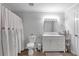 Neutral bathroom featuring a white vanity and cabinet, toilet, and shower with patterned curtain at 1539 School House Run, Dacula, GA 30019