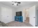 Neutral bedroom featuring plush carpet, ceiling fan, and a blue media console at 1539 School House Run, Dacula, GA 30019