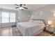 Well-lit bedroom with wood floors, double windows and closets, and a comfortable bed at 1539 School House Run, Dacula, GA 30019