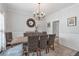 Dining room with wainscotting, chandelier and large table for hosting gatherings at 1539 School House Run, Dacula, GA 30019