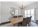 Dining room featuring a rustic table, modern chandelier, and plantation shutters at 1539 School House Run, Dacula, GA 30019