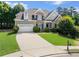 Charming two-story home featuring a manicured lawn and brick and gray siding at 1539 School House Run, Dacula, GA 30019