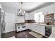 This kitchen features stainless steel appliances, white cabinets, and an elegant backsplash at 1539 School House Run, Dacula, GA 30019