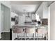 Updated kitchen showcases a marble countertop and seating at the breakfast bar at 1539 School House Run, Dacula, GA 30019