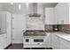 Kitchen featuring white cabinets, granite countertops, stainless steel hood vent and appliances at 1539 School House Run, Dacula, GA 30019