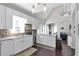 Bright kitchen features recessed lighting, white cabinets and eat-in breakfast bar at 1539 School House Run, Dacula, GA 30019