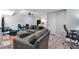 Open-concept living room featuring comfortable furniture, modern lighting and a kitchenette at 1539 School House Run, Dacula, GA 30019