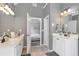 Main bathroom featuring dual vanities, tile floor, and entry to bedroom at 1539 School House Run, Dacula, GA 30019