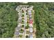 Stunning aerial capture of a home in a peaceful neighborhood surrounded by mature trees at 1530 Parkside Village Dr, Cumming, GA 30040
