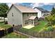 Well-kept back exterior featuring an expansive backyard with mature trees and privacy fence at 1530 Parkside Village Dr, Cumming, GA 30040