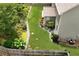 Well-maintained backyard with lush green grass, beautiful landscaping, and a charming picket fence at 1530 Parkside Village Dr, Cumming, GA 30040
