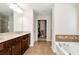 Expansive main bathroom features double sinks, a soaking tub, and a separate shower for spa-like comfort at 1530 Parkside Village Dr, Cumming, GA 30040