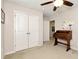 Bright bedroom with ceiling fan and built-in desk at 1530 Parkside Village Dr, Cumming, GA 30040