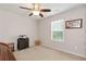 Bright bedroom with a ceiling fan, natural light, and neutral decor at 1530 Parkside Village Dr, Cumming, GA 30040