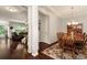 Dining room with chandelier and hardwood floors seamlessly connecting to the living room at 1530 Parkside Village Dr, Cumming, GA 30040
