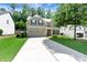 Charming two-story home with a spacious driveway and well-maintained landscaping at 1530 Parkside Village Dr, Cumming, GA 30040