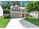 Charming two-story home with a well-manicured lawn, two car garage, and inviting front porch at 1530 Parkside Village Dr, Cumming, GA 30040