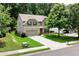 Charming two-story home with a well-manicured lawn, mature trees, and a spacious driveway at 1530 Parkside Village Dr, Cumming, GA 30040