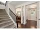 Inviting foyer with hardwood floors, a staircase, and views into the dining room and front door at 1530 Parkside Village Dr, Cumming, GA 30040