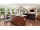Open kitchen with granite island, stainless appliances, and dining area at 1530 Parkside Village Dr, Cumming, GA 30040