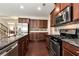 Well-equipped kitchen with granite counters, stainless appliances, and hardwood floors at 1530 Parkside Village Dr, Cumming, GA 30040