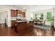 Open kitchen with granite island, stainless appliances, and adjacent dining space at 1530 Parkside Village Dr, Cumming, GA 30040