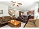 Open-concept living room with hardwood floors, comfortable seating, and views into the kitchen at 1530 Parkside Village Dr, Cumming, GA 30040