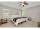 Bright main bedroom with trey ceiling, two windows, and carpet flooring features a restful retreat at 1530 Parkside Village Dr, Cumming, GA 30040