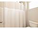 Cozy bathroom featuring a toilet and a shower with curtain at 1530 Parkside Village Dr, Cumming, GA 30040