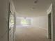 Spacious unfinished bonus room with fresh paint and natural light from a window at 5381 Tuscany Dr, Douglasville, GA 30135