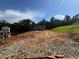 New home with a brick facade, surrounded by a wooded landscape, awaits landscaping and finishing touches at 5381 Tuscany Dr, Douglasville, GA 30135
