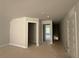 Hallway with natural light streaming through the window and doors ready for paint and carpet at 5381 Tuscany Dr, Douglasville, GA 30135
