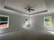 Unfinished main bedroom featuring tray ceiling, recessed lighting, and generous natural light at 5381 Tuscany Dr, Douglasville, GA 30135