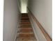 Unfinished stairway with wood handrail leading to the upper level of the home at 5381 Tuscany Dr, Douglasville, GA 30135