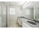 Bathroom featuring dual sinks, a large mirror, and a glass-enclosed shower at 3604 Cameron Hills Pl, Ellenwood, GA 30294