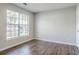 Bedroom featuring a large window allowing ample natural light and luxury vinyl plank flooring at 3604 Cameron Hills Pl, Ellenwood, GA 30294