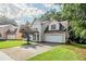 Two-story home featuring an attached two car garage and a well maintained lawn at 3604 Cameron Hills Pl, Ellenwood, GA 30294