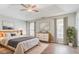 Spacious main bedroom with tray ceilings, neutral walls, and lots of natural light at 3604 Cameron Hills Pl, Ellenwood, GA 30294