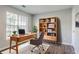 Well-lit home office features a modern desk, ample storage, and stylish decor at 3604 Cameron Hills Pl, Ellenwood, GA 30294