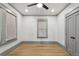 Empty bedroom features gray trim, hardwood flooring, and neutral window coverings at 531 Atlanta Se Ave, Atlanta, GA 30315
