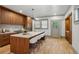A spacious kitchen with wood cabinets, a stone island with seating, and stainless steel appliances at 531 Atlanta Se Ave, Atlanta, GA 30315
