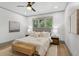 Serene main bedroom with a large window, neutral color palette, and hardwood floors at 531 Atlanta Se Ave, Atlanta, GA 30315
