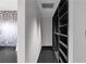 This walk-in closet features built-in shelving and modern black and white wallpaper at 199 14Th Ne St # 3003, Atlanta, GA 30309
