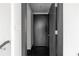 Hallway interior featuring sleek, dark-colored doors and trim against a white wall and gray staircase detail at 199 14Th Ne St # 3003, Atlanta, GA 30309