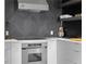 The well-equipped kitchen features stainless steel appliances, black accents and a herringbone backsplash at 199 14Th Ne St # 3003, Atlanta, GA 30309