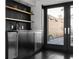 Kitchenette with black tile and open shelving next to an outdoor patio at 199 14Th Ne St # 3003, Atlanta, GA 30309