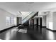 Contemporary living area with dark floors, a glass-railed staircase, and open layout at 199 14Th Ne St # 3003, Atlanta, GA 30309
