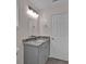A bathroom featuring a granite countertop vanity with modern lighting and fixtures at 250 Stonecreek Pkwy, Covington, GA 30016