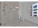 Modern bathroom features a frameless glass shower, sleek fixtures, and a bright window at 345 Sugarview Rd, Sugar Hill, GA 30518