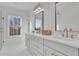 Elegant Primary bathroom featuring double sinks, quartz countertops, and a seamless glass shower enclosure at 345 Sugarview Rd, Sugar Hill, GA 30518